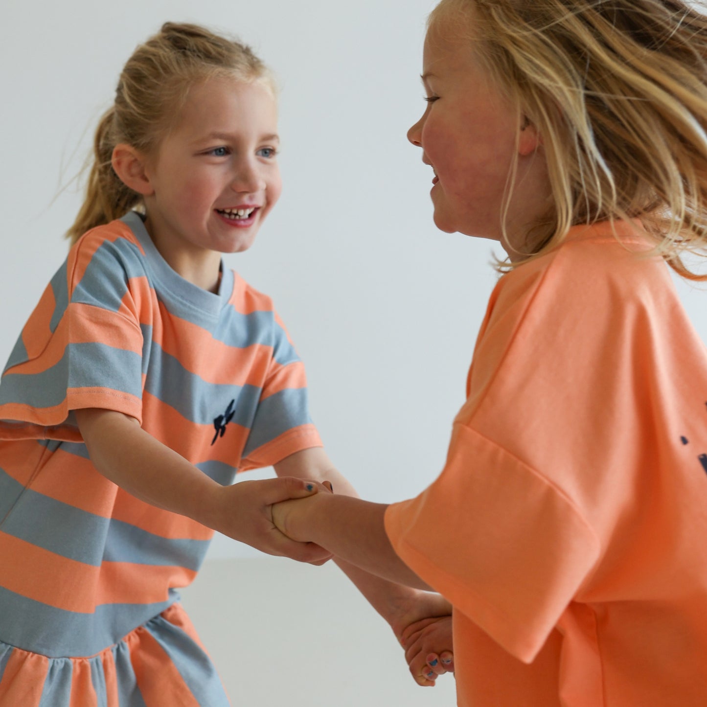 Children’s organic cotton Sherbet Stripe Dress by OLLE, with drop waist, bold stripes, and chest embroidery