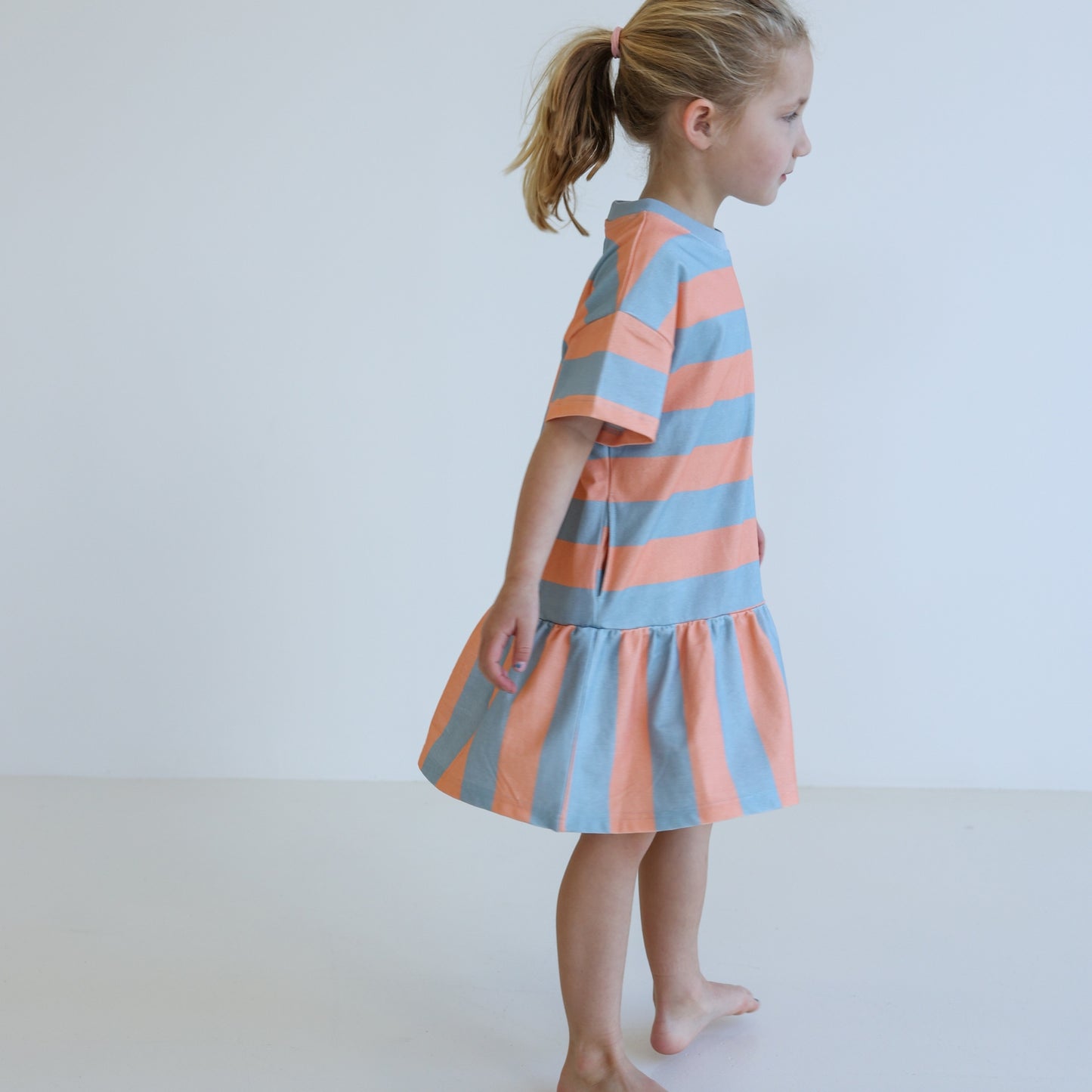 Children’s organic cotton Sherbet Stripe Dress by OLLE, with drop waist, bold stripes, and chest embroidery