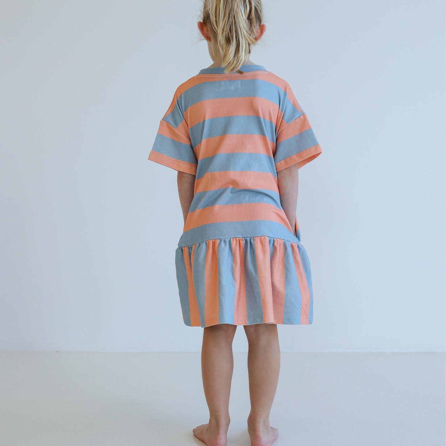 Children’s organic cotton Sherbet Stripe Dress by OLLE, with drop waist, bold stripes, and chest embroidery