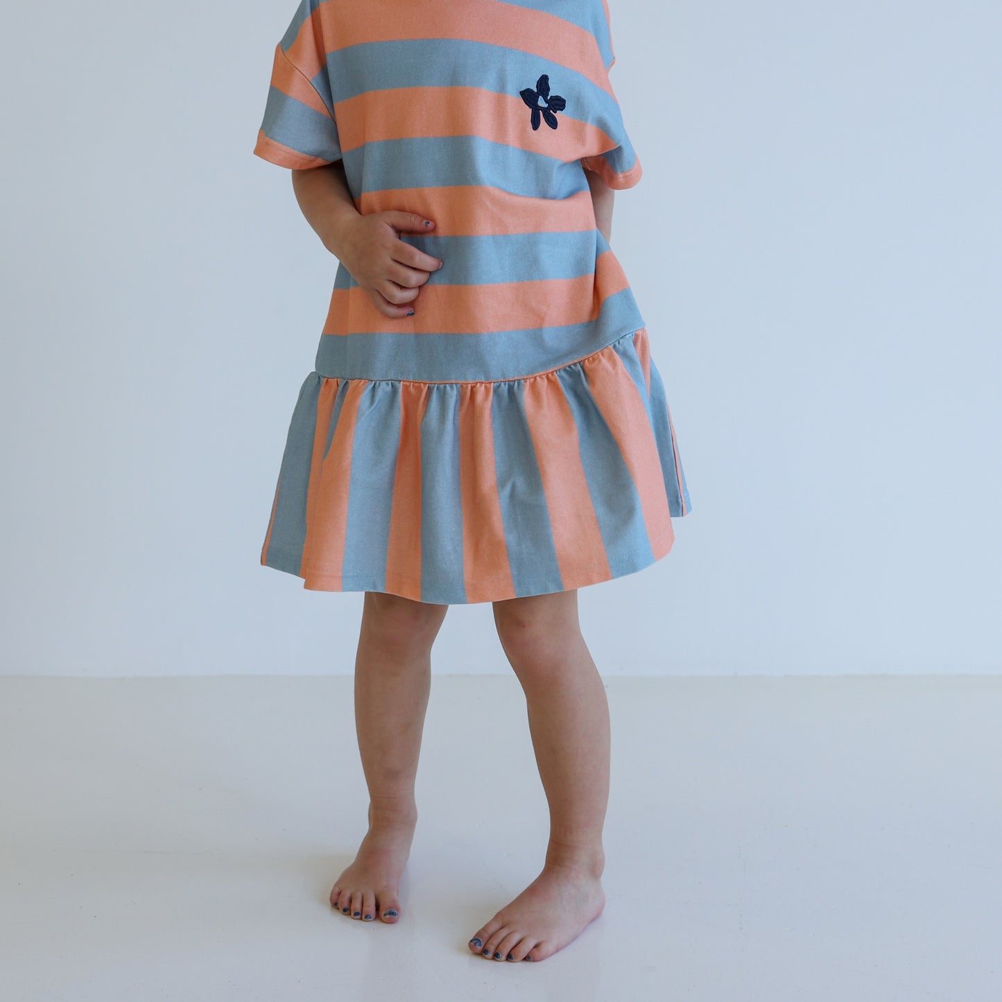 Children’s organic cotton Sherbet Stripe Dress by OLLE, with drop waist, bold stripes, and chest embroidery