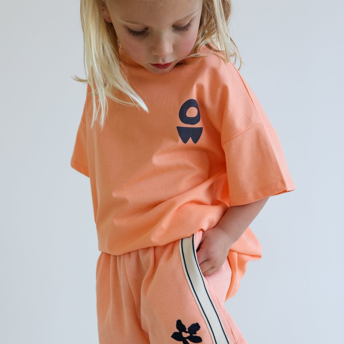 Children’s oversized organic cotton It’s Cool Tee by OLLE, with ‘It’s cool to care’ motto printed on back.
