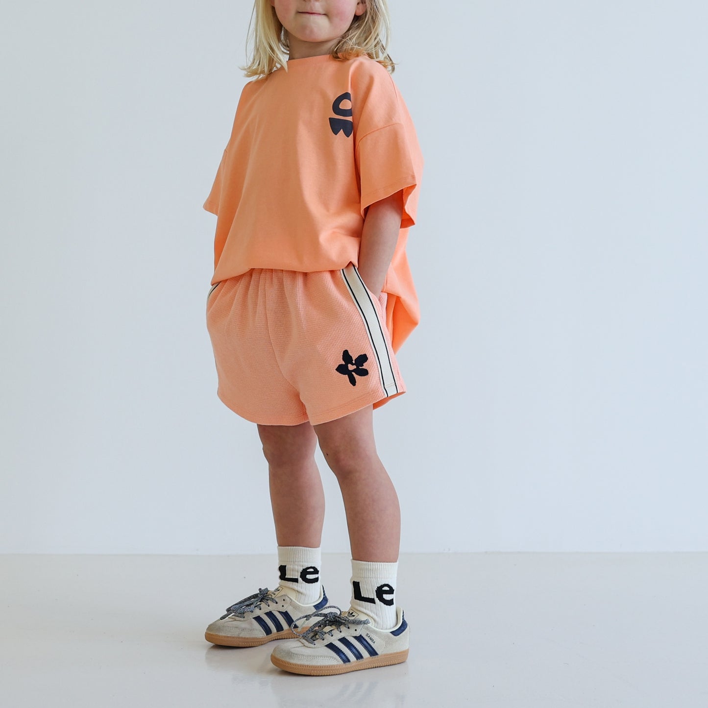 Children’s oversized organic cotton It’s Cool Tee by OLLE, with ‘It’s cool to care’ motto printed on back.