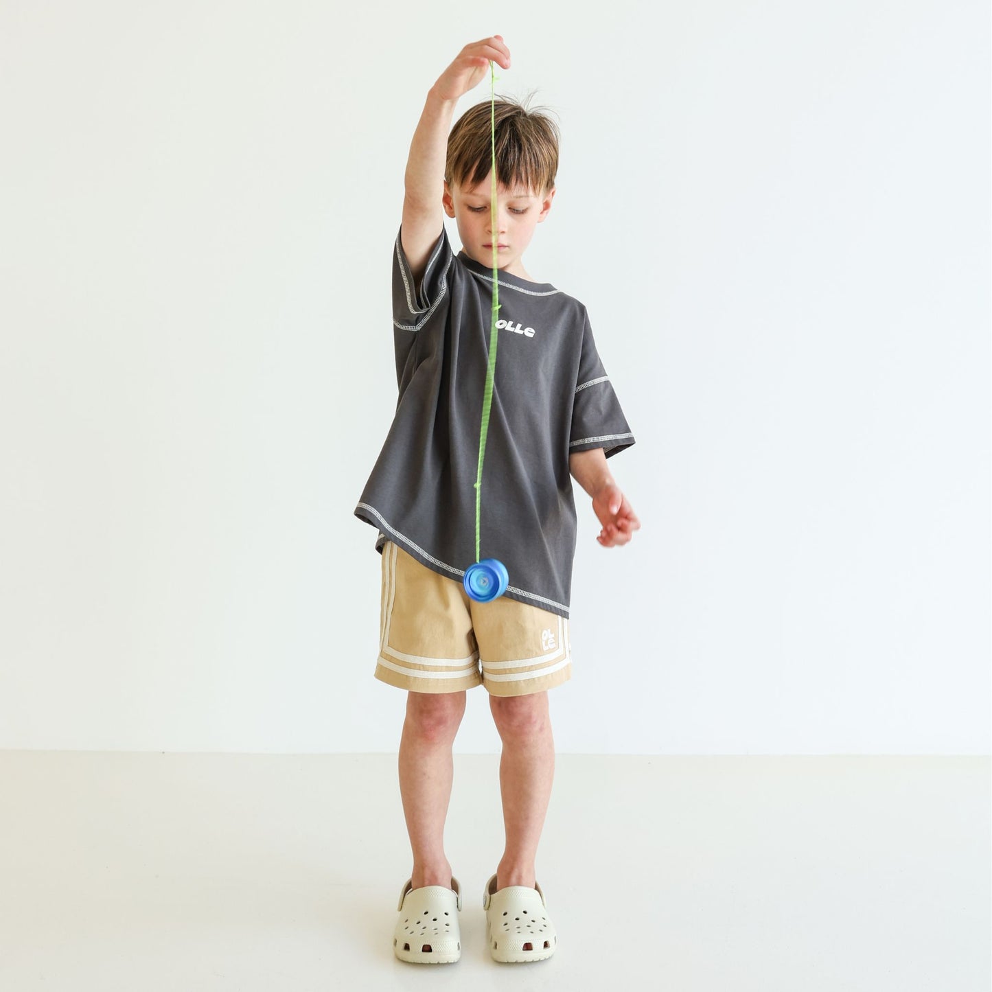 Children’s oversized organic cotton Topstitch Tee in Charcoal by OLLE, with contrast stitch and skate logo.