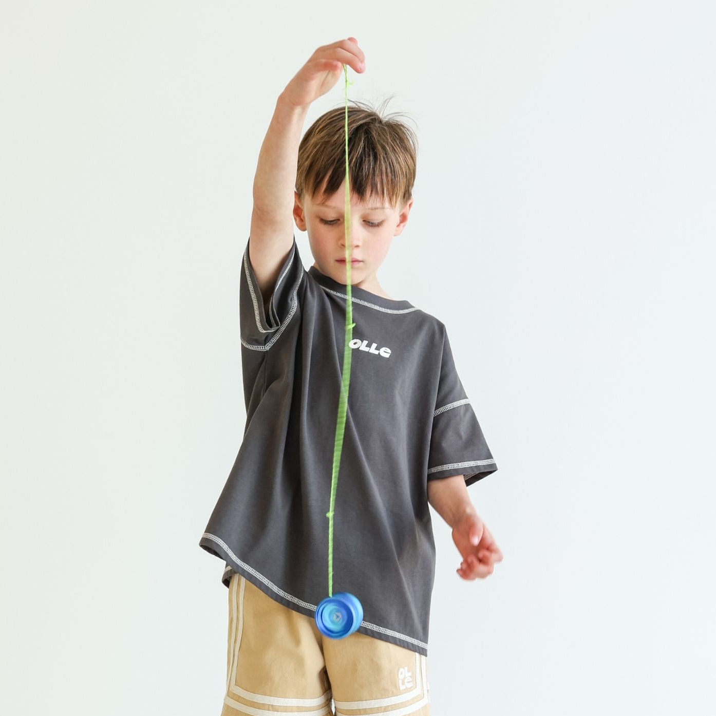 Children’s oversized organic cotton Topstitch Tee in Charcoal by OLLE, with contrast stitch and skate logo.