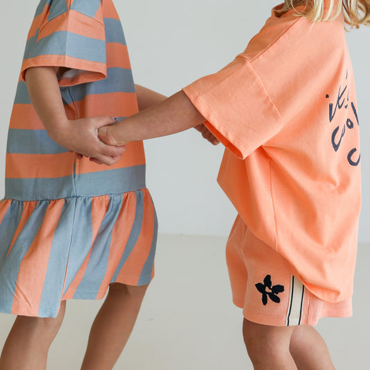Children’s organic cotton Sherbet Stripe Dress by OLLE, with drop waist, bold stripes, and chest embroidery