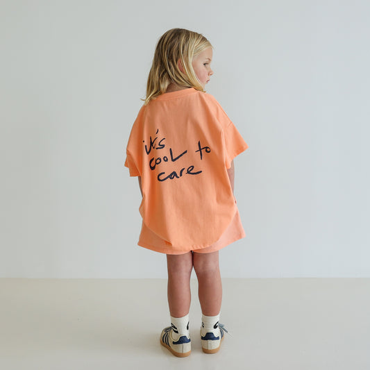 Children’s oversized organic cotton It’s Cool Tee by OLLE, with ‘It’s cool to care’ motto printed on back.