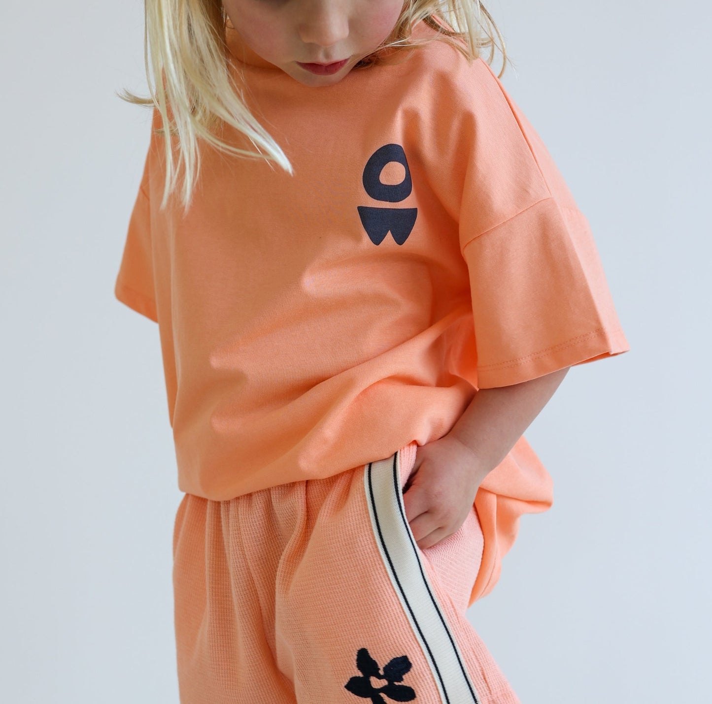 Children’s oversized organic cotton It’s Cool Tee by OLLE, with ‘It’s cool to care’ motto printed on back.