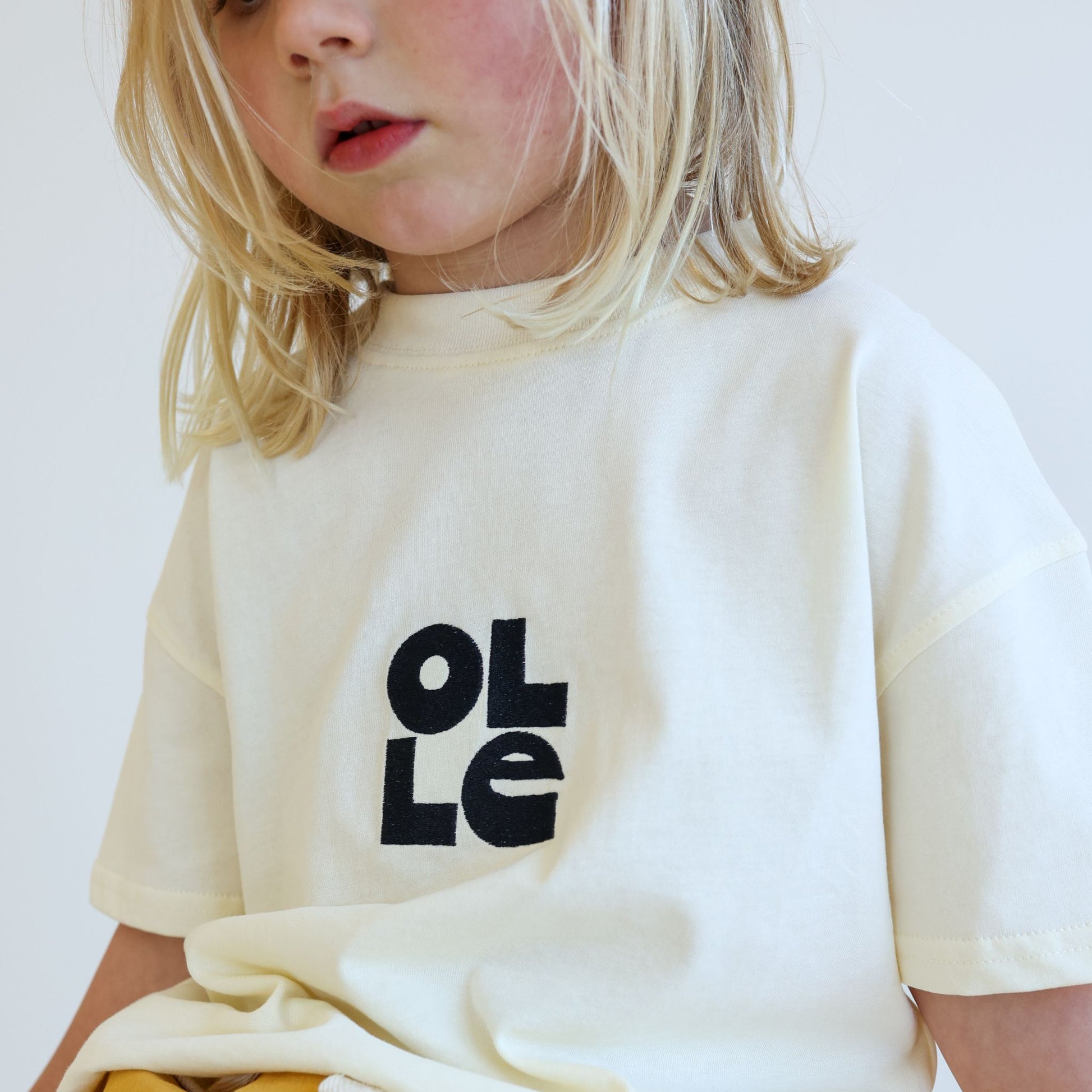 Children’s organic cotton OG Tee in Ecru by OLLE, with Midnight embroidery and relaxed fit
