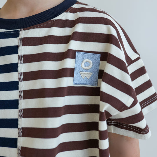Children’s oversized organic cotton Split Stripes Tee by OLLE, with yarn-dyed stripe panels, contrast stitch, and chest embroidery.