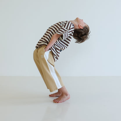 Children’s oversized organic cotton Split Stripes Tee by OLLE, with yarn-dyed stripe panels, contrast stitch, and chest embroidery.
