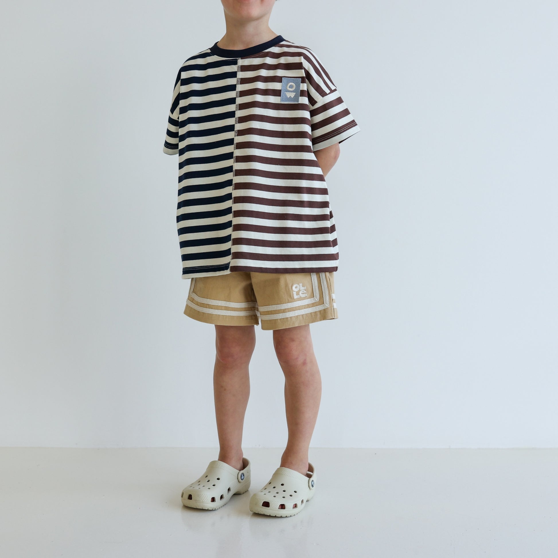 Children’s oversized organic cotton Split Stripes Tee by OLLE, with yarn-dyed stripe panels, contrast stitch, and chest embroidery