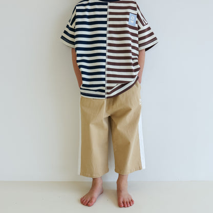 Children’s oversized organic cotton Split Stripes Tee by OLLE, with yarn-dyed stripe panels, contrast stitch, and chest embroidery.